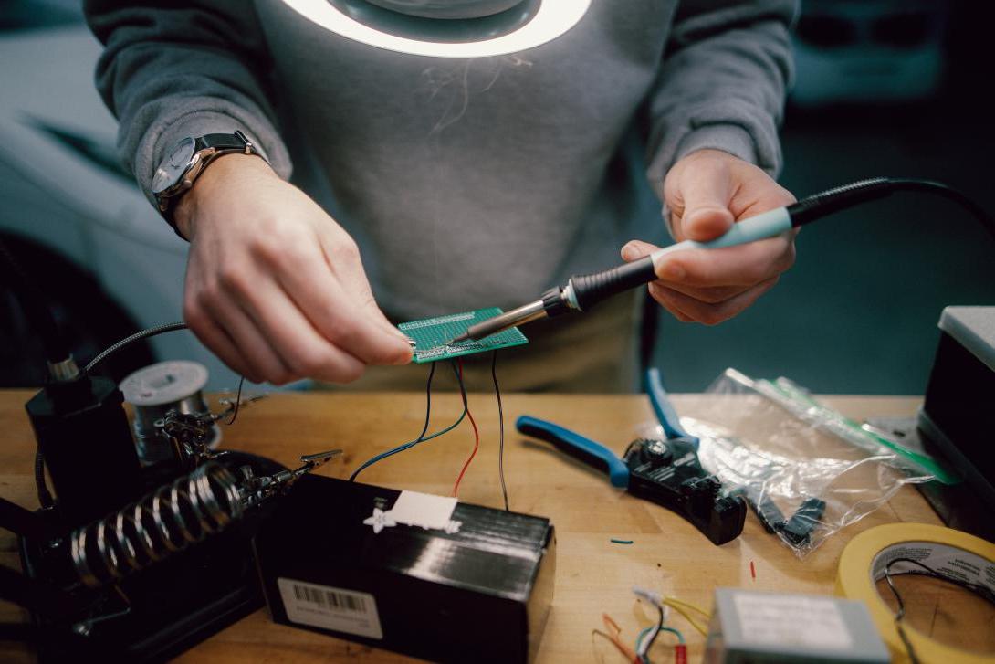 computer engineering student working on computer panel